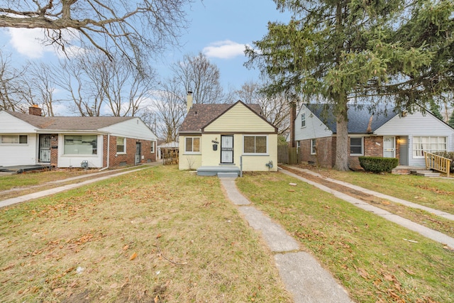 bungalow-style home featuring a front yard