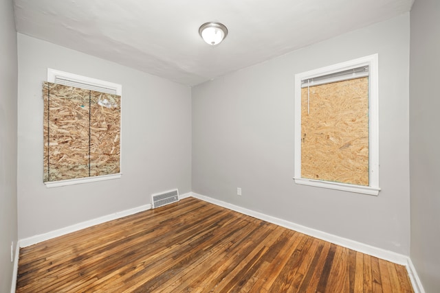 unfurnished room featuring hardwood / wood-style floors