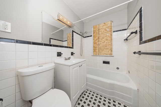 full bathroom with tiled shower / bath combo, vanity, tile walls, and toilet