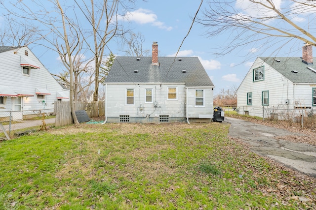 rear view of property with a lawn