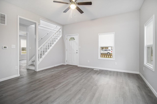 322 Emmons St, Niles, MI 49120 - unfurnished living room featuring ceiling fan, stairs, and dark wood-style flooring