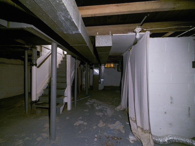 basement featuring heating unit and water heater