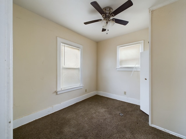 carpeted empty room with plenty of natural light and ceiling fan