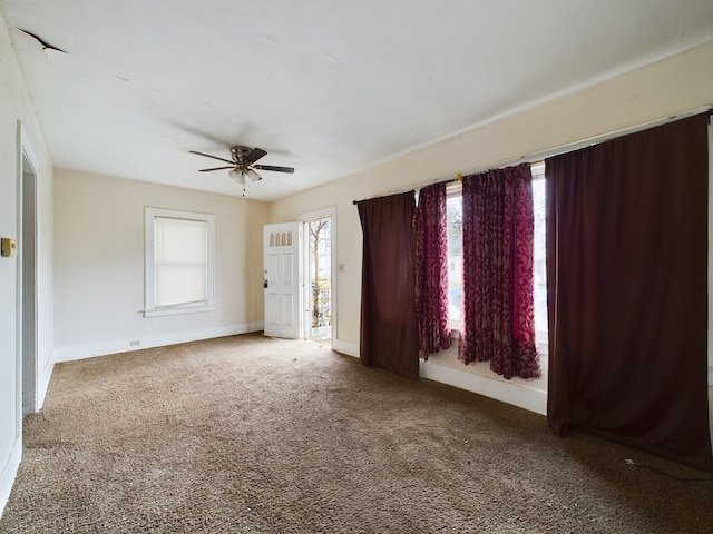 spare room featuring carpet flooring and ceiling fan