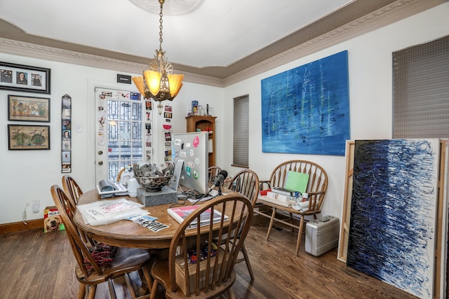 dining room with dark hardwood / wood-style flooring, an inviting chandelier, and crown molding