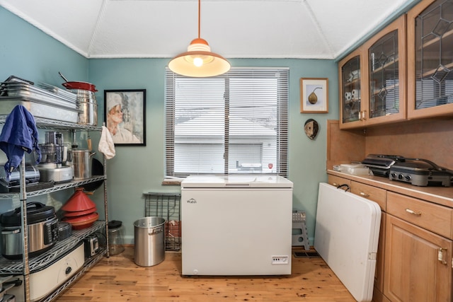 laundry room featuring cabinets and light hardwood / wood-style flooring