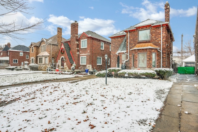 view of snow covered rear of property