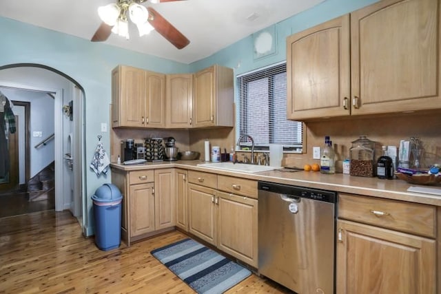 kitchen featuring ceiling fan, sink, light brown cabinets, stainless steel dishwasher, and light wood-type flooring