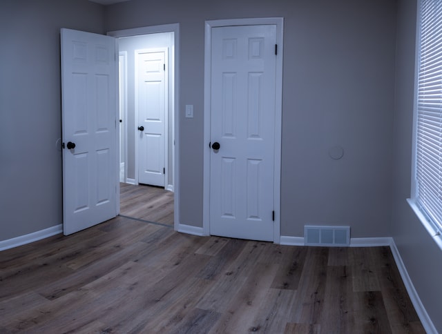 unfurnished bedroom featuring light hardwood / wood-style flooring and multiple windows