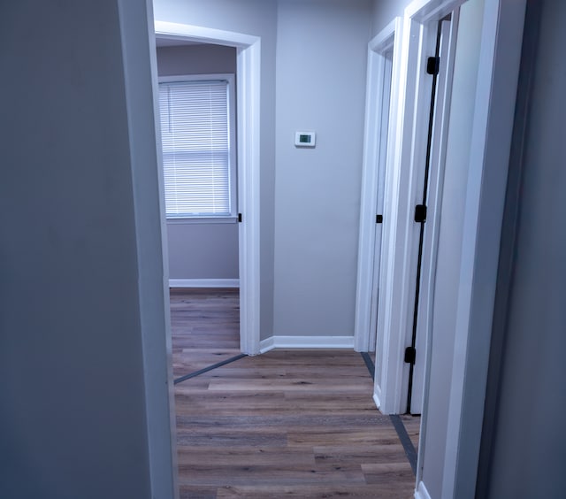 corridor with light wood-type flooring