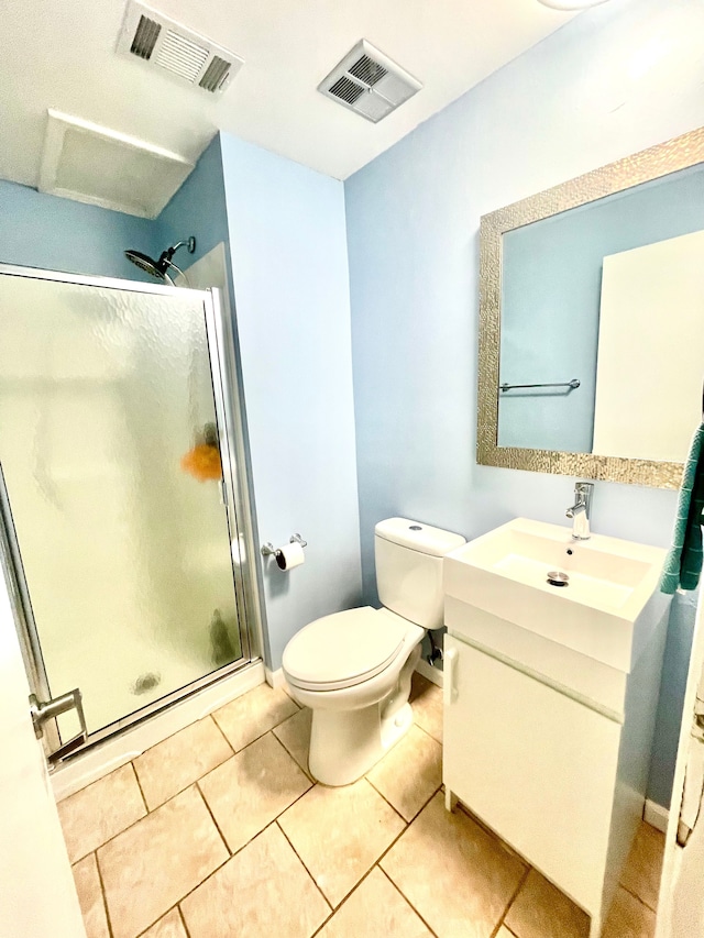 bathroom featuring toilet, vanity, tile patterned floors, and walk in shower