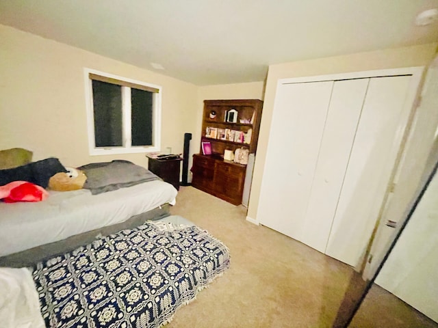 carpeted bedroom with a closet