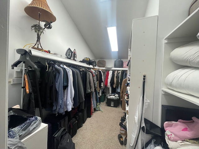 spacious closet with carpet flooring and vaulted ceiling