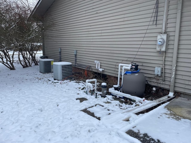 view of snow covered exterior with central air condition unit