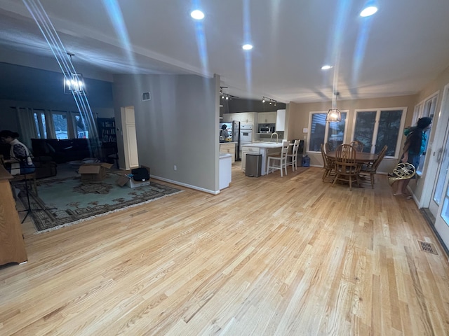 living room with light hardwood / wood-style floors and sink