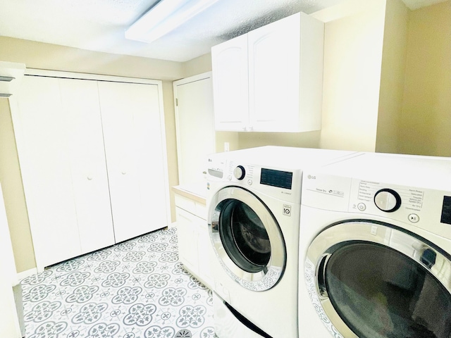 laundry room featuring cabinets and washer and dryer