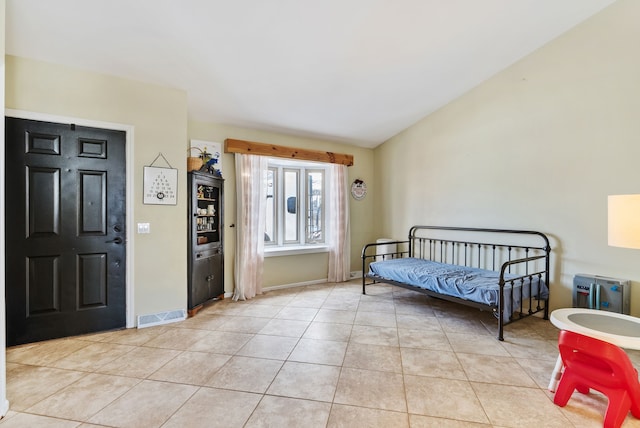 foyer entrance with light tile patterned floors and lofted ceiling