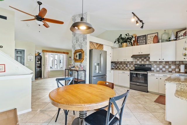 kitchen with decorative light fixtures, light tile patterned floors, stainless steel appliances, and white cabinetry