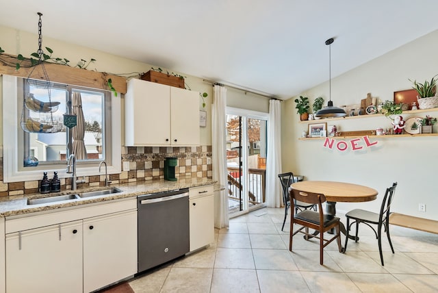 kitchen with sink, white cabinets, stainless steel dishwasher, and plenty of natural light