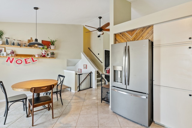 kitchen featuring ceiling fan, hanging light fixtures, stainless steel fridge with ice dispenser, high vaulted ceiling, and light tile patterned floors