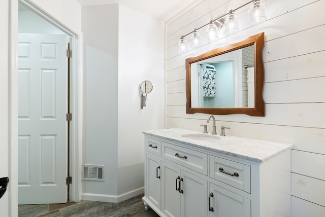 bathroom featuring vanity and hardwood / wood-style flooring