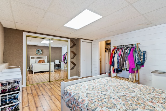 bedroom featuring hardwood / wood-style floors and a paneled ceiling