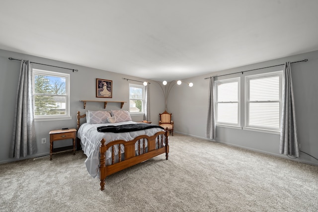 carpeted bedroom featuring multiple windows