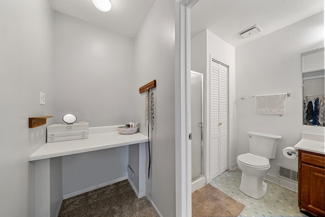 bathroom featuring vanity, toilet, and walk in shower