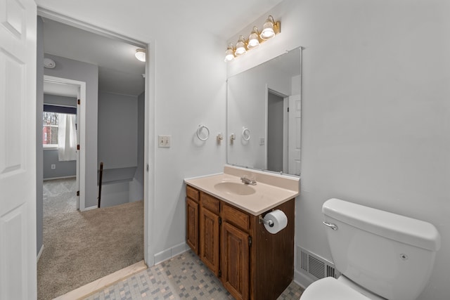 bathroom featuring vanity and toilet