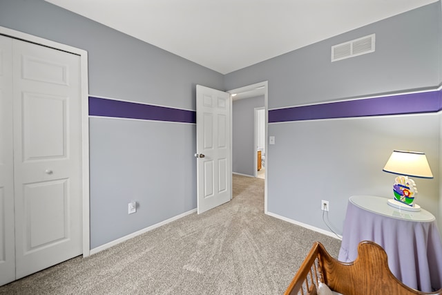 bedroom with a closet and light colored carpet