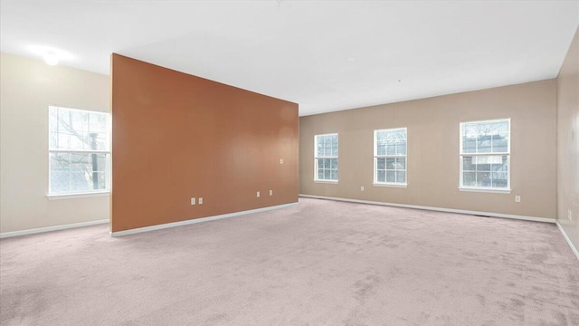 spare room featuring light colored carpet