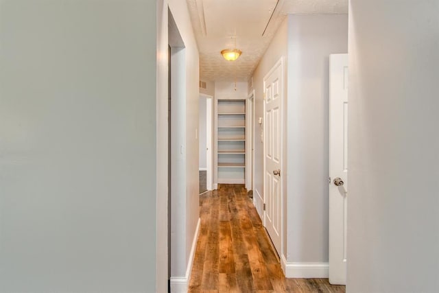 hall with hardwood / wood-style floors