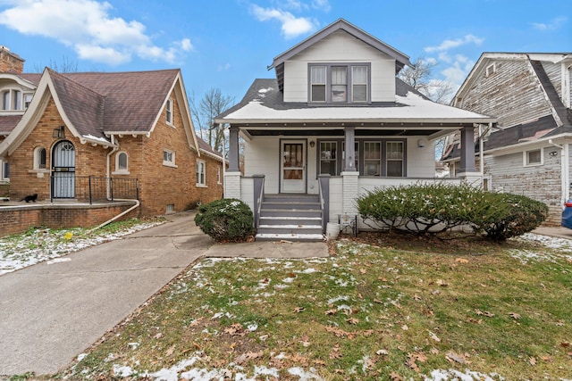 bungalow-style home featuring a porch and a front lawn