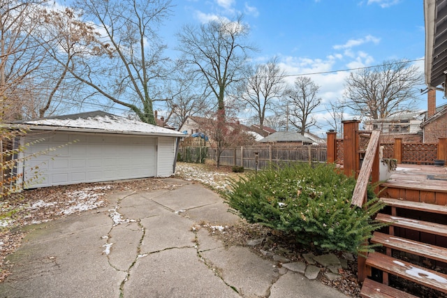 exterior space featuring a deck, an outdoor structure, and a garage