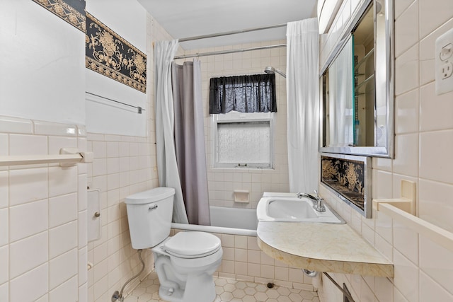 full bathroom featuring tile patterned flooring, shower / tub combo with curtain, tile walls, and toilet