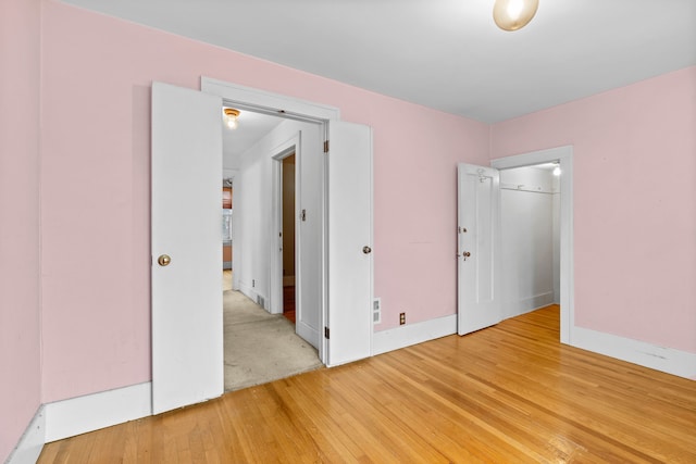 unfurnished room with wood-type flooring