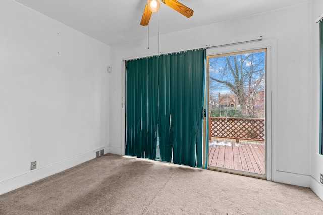 carpeted empty room featuring ceiling fan