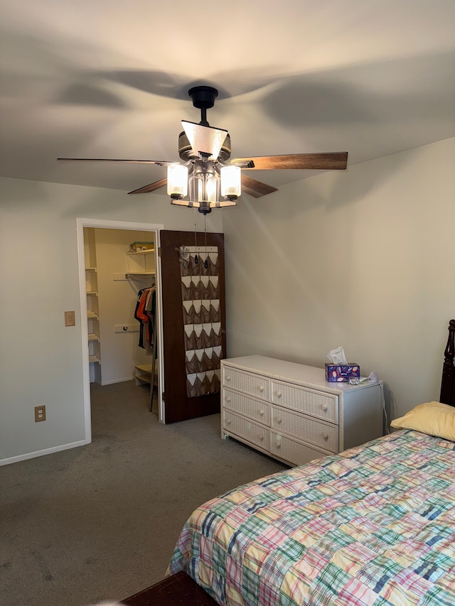 carpeted bedroom featuring ceiling fan, a spacious closet, and a closet