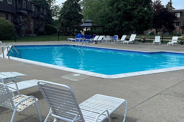 view of swimming pool with a gazebo and a patio area