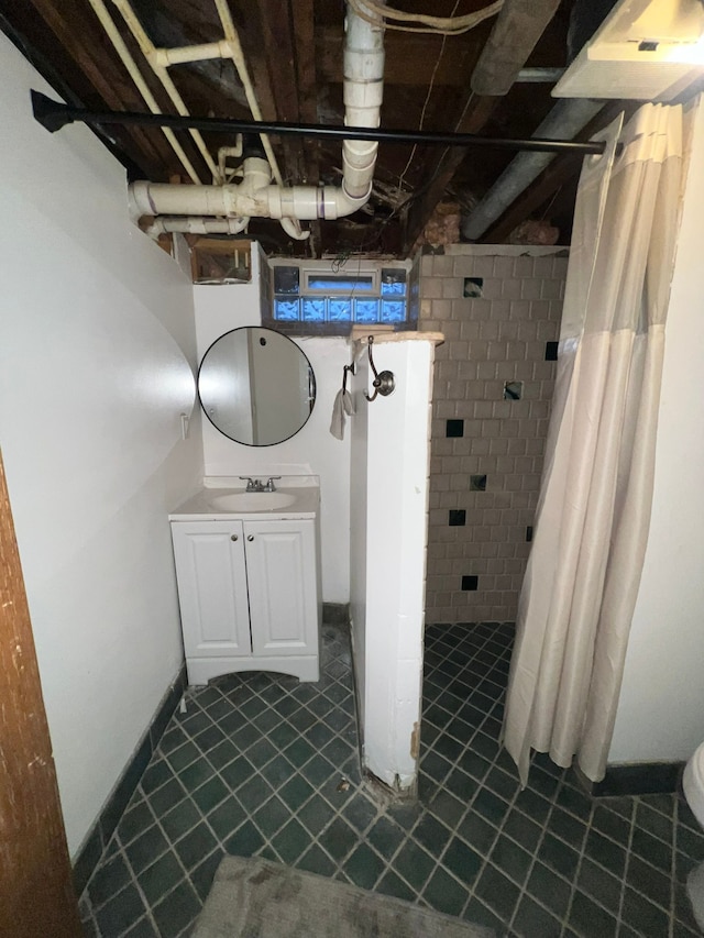 bathroom featuring vanity and curtained shower