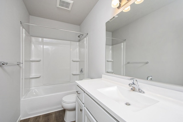 full bath featuring wood finished floors, toilet, shower / washtub combination, vanity, and visible vents
