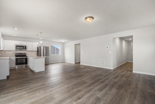 unfurnished living room featuring recessed lighting, visible vents, baseboards, and dark wood finished floors