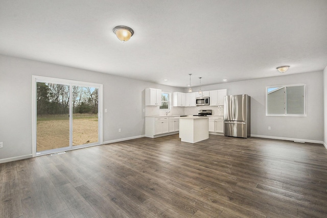unfurnished living room featuring dark wood finished floors and baseboards
