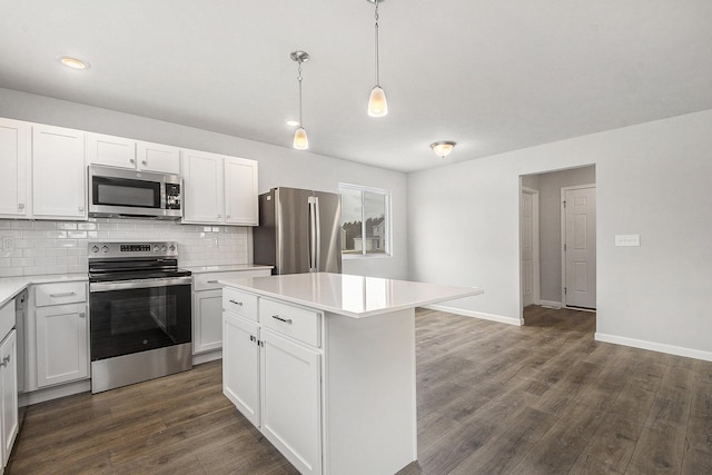 kitchen with stainless steel appliances, dark wood-style flooring, light countertops, and decorative backsplash