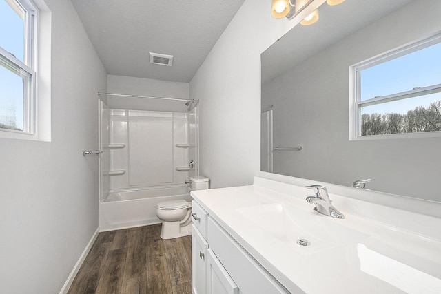 full bath with vanity, toilet, visible vents, tub / shower combination, and wood finished floors