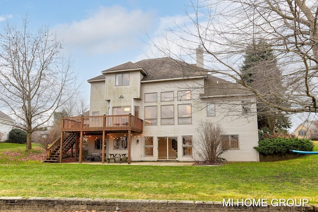 back of house featuring a lawn, a patio, and a wooden deck