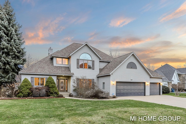 front facade with a lawn and a garage