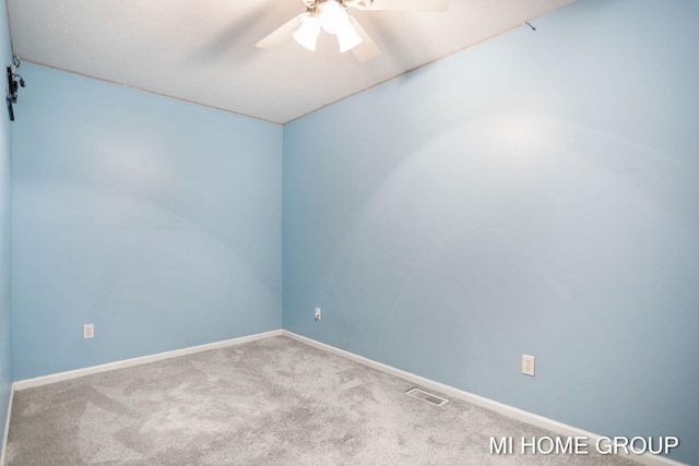 carpeted spare room with ceiling fan