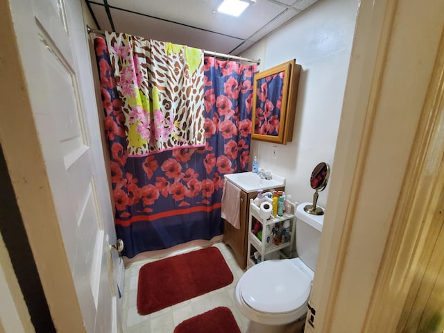 bathroom with vanity, a shower with curtain, a paneled ceiling, and toilet