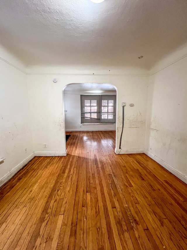 unfurnished room with hardwood / wood-style floors